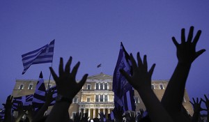 Protesters raise their arms during a rally against austerity economic measures and corruption in Athens